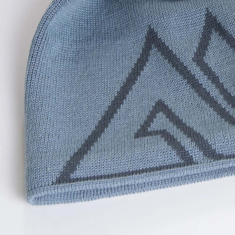Detailed close-up of fog blue merino wool beanie showing knit texture and logo