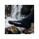 Close-up of a foot wearing Extremities waterproof sock standing in a flowing stream, emphasizing waterproof capability.