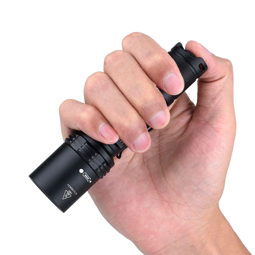 Angled view of the black Fitorch P200 flashlight with side button and large head