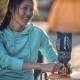 Woman Using Jetboil Flash Stove at Campsite – Outdoor Cooking Scene Camper using Jetboil Flash 1.0L stove with Jetpower fuel at campsite, smiling next to tent