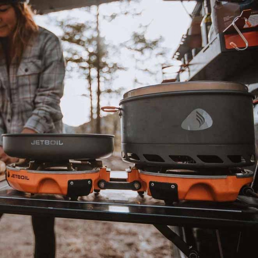 Jetboil Genesis Stove Partially Folded Open Jetboil Genesis Base Camp Stove partially unfolded, showing one active burner and hinge system.
