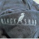 Close-up of slate blue cotton poncho towel showing soft terry fabric texture and embroidered Black Shag logo detail