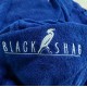 Close-up of electric blue cotton poncho towel showing soft terry fabric texture and embroidered Black Shag logo detail