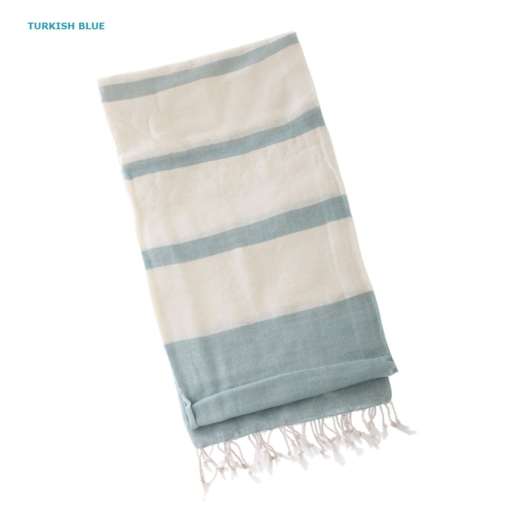 Set of three Turkish hand-loomed flat-weave cotton beach towels in blue grey and orange striped designs with tassel fringe lightweight quick dry fabric for beach and travel use