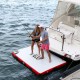 People fishing from Aqua Marina inflatable air platform attached beside luxury yacht on open water ideal for relaxing swimming and marine recreation