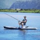 Person fishing from paddleboard using Aqua Marina cooler seat accessory designed for SUP fishing boating outdoor recreation and water adventures